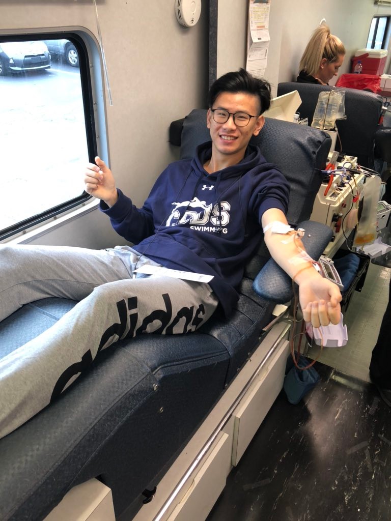 Young male donor giving blood on Hoxwort Donor Bus