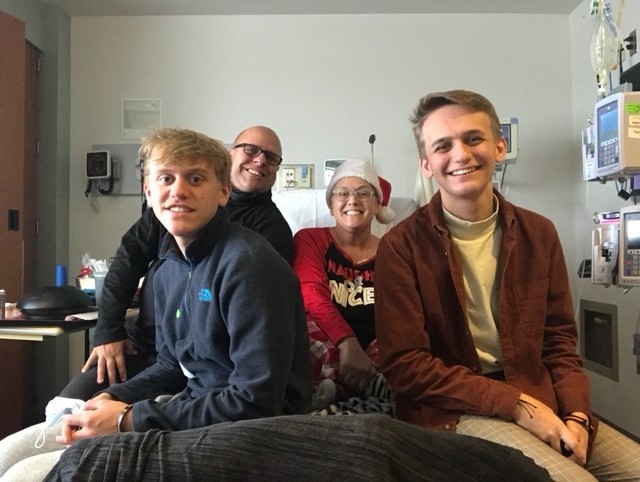 Karen and family on the hospital bed