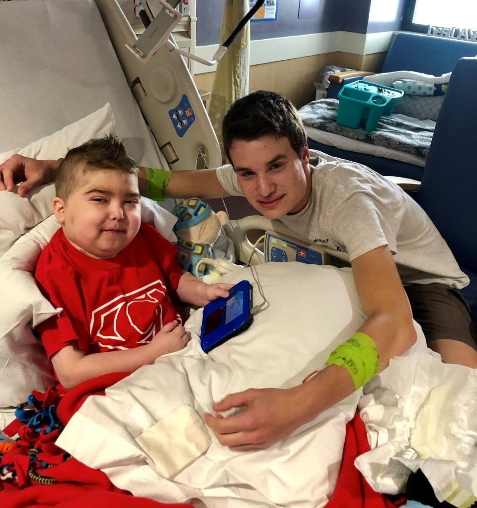 Cohen in a hospital bed wit his older brother T.C. beside him