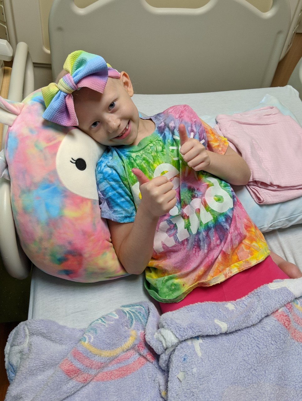 Emma smiling in hospital bed